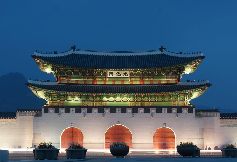 The historic Gyeongbokgung Palace in Seoul with mountains behind it